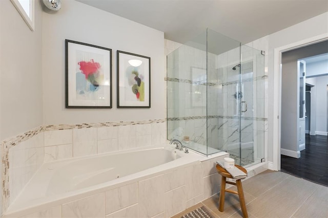 bathroom featuring wood-type flooring and independent shower and bath