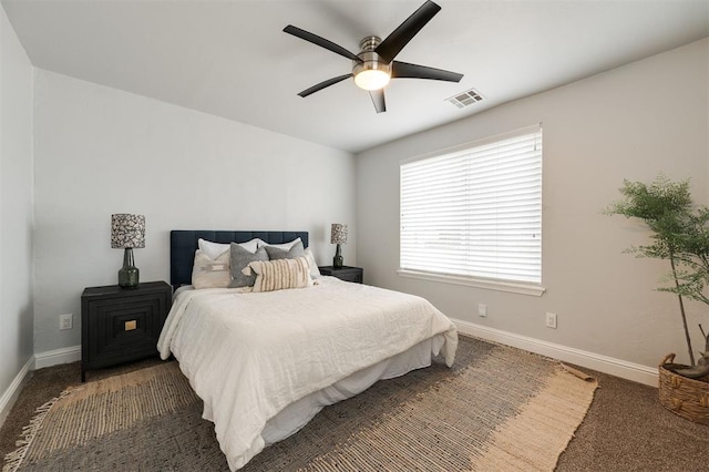 bedroom with ceiling fan and dark colored carpet