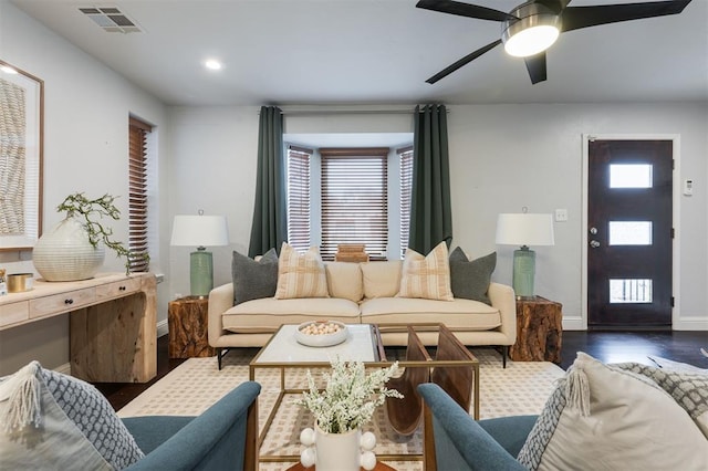 living room featuring ceiling fan, a wealth of natural light, and dark hardwood / wood-style flooring