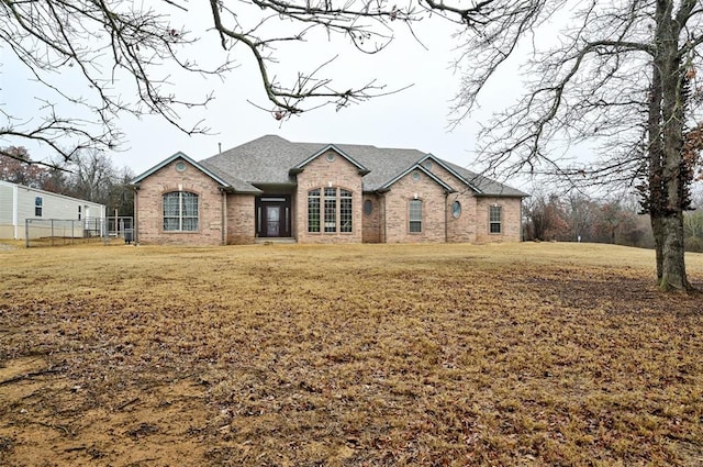 french country style house featuring a front yard