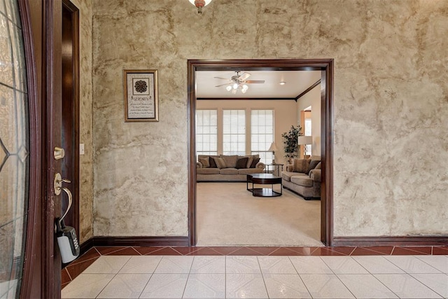 unfurnished living room featuring crown molding, ceiling fan, and tile patterned flooring