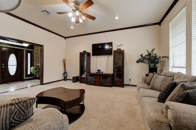 carpeted living room with crown molding and ceiling fan