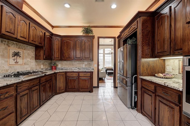 kitchen featuring light tile patterned flooring, dark brown cabinets, ornamental molding, appliances with stainless steel finishes, and light stone countertops