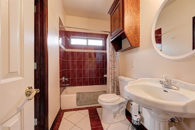 full bathroom with sink, shower / bath combination with curtain, tile patterned floors, and toilet