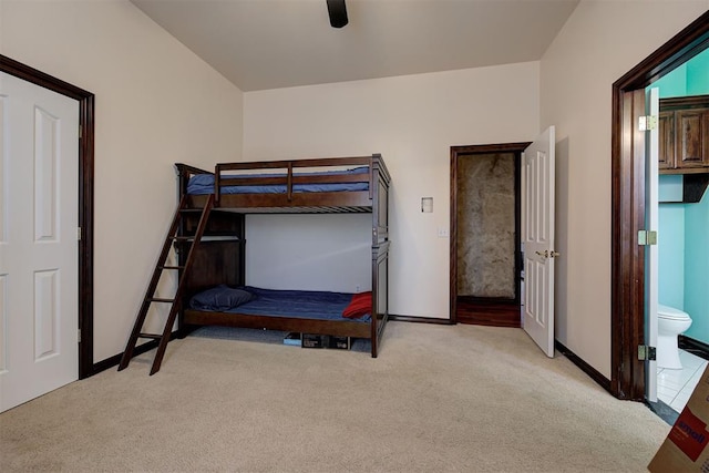 unfurnished bedroom featuring light carpet, connected bathroom, and ceiling fan