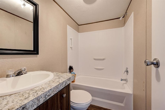 full bathroom with bathing tub / shower combination, vanity, a textured ceiling, and toilet