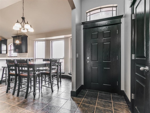 foyer featuring a high ceiling and a notable chandelier