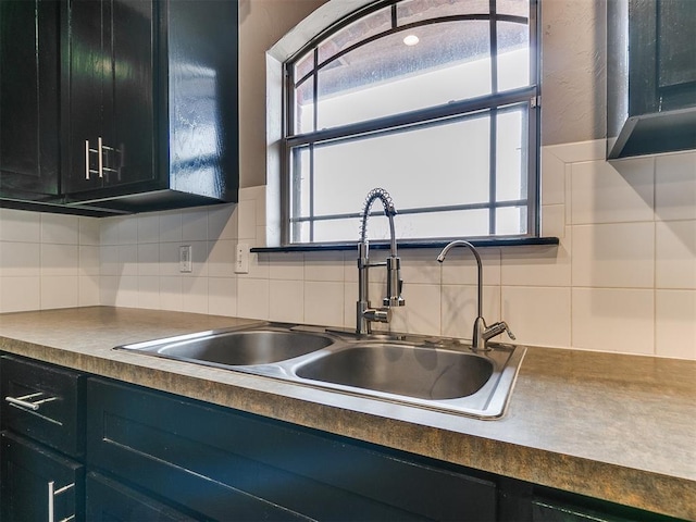 kitchen featuring sink, decorative backsplash, and a healthy amount of sunlight