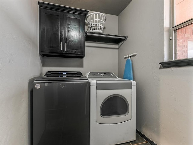 laundry area featuring cabinets and washer and clothes dryer