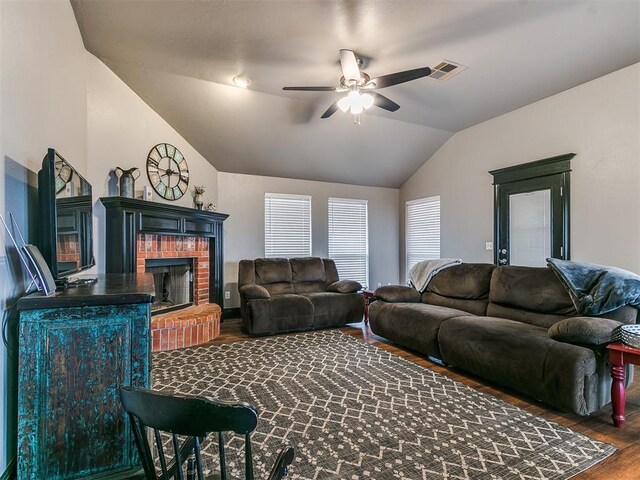 living room featuring ceiling fan, a fireplace, lofted ceiling, and dark hardwood / wood-style floors