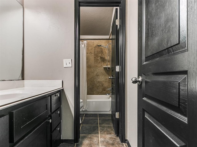 full bathroom featuring vanity, a textured ceiling, toilet, and shower / bath combo