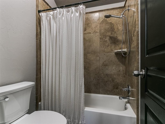 bathroom with shower / tub combo and toilet