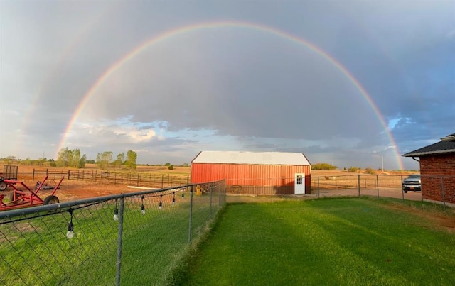 view of yard with a rural view and an outbuilding