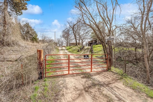 view of gate with a rural view