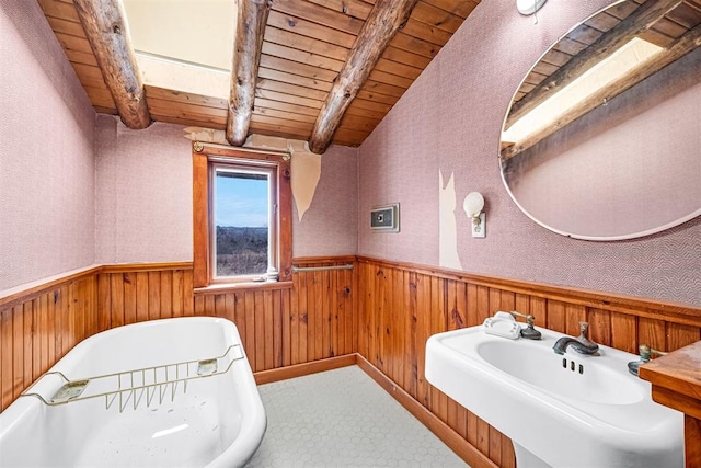 bathroom featuring sink, lofted ceiling with beams, wooden ceiling, and wood walls