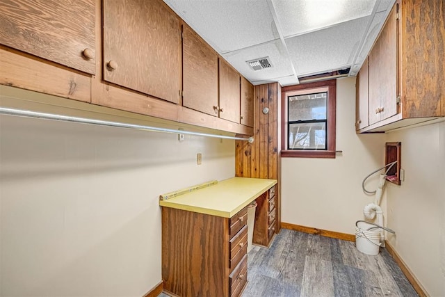 laundry area with dark wood-type flooring