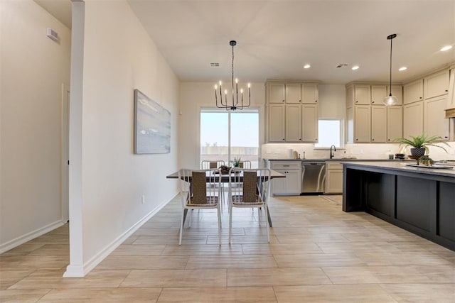 kitchen with a chandelier, decorative light fixtures, dishwasher, and cream cabinetry