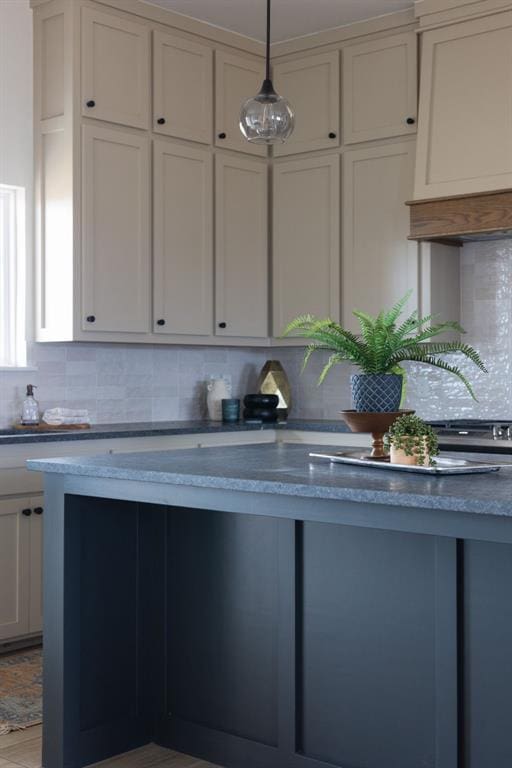 kitchen with decorative backsplash and hanging light fixtures