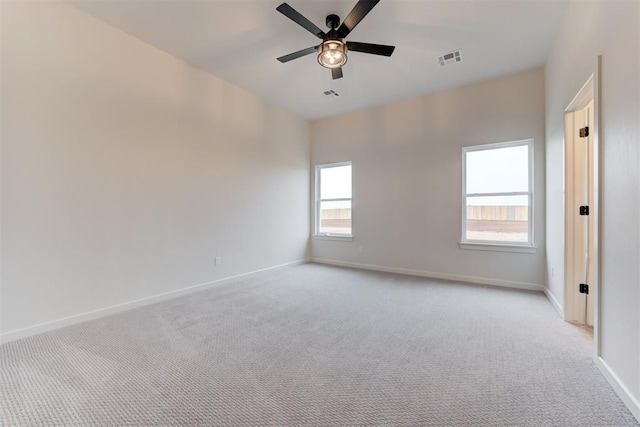 carpeted spare room with ceiling fan