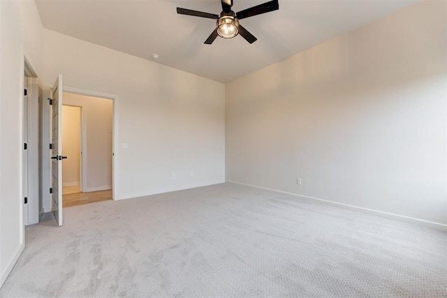 spare room with light carpet and ceiling fan
