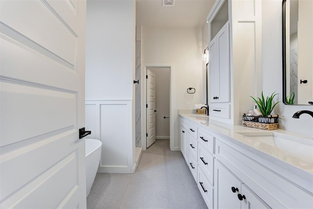 bathroom with vanity and a bath