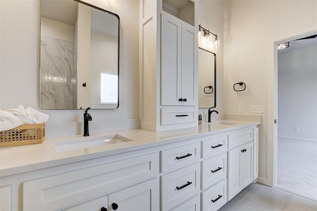bathroom with tile patterned flooring and vanity