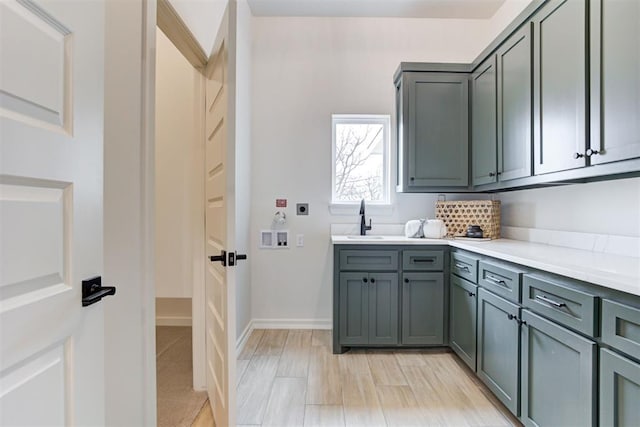 laundry room with cabinets, washer hookup, hookup for an electric dryer, and sink