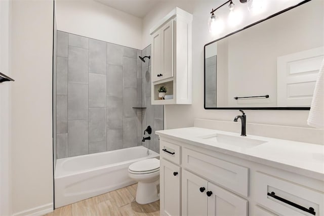 full bathroom with vanity, toilet, tiled shower / bath combo, and wood-type flooring