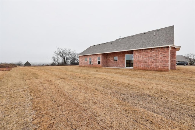 back of property with a yard