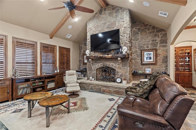 living room featuring beamed ceiling, ceiling fan, high vaulted ceiling, and a fireplace