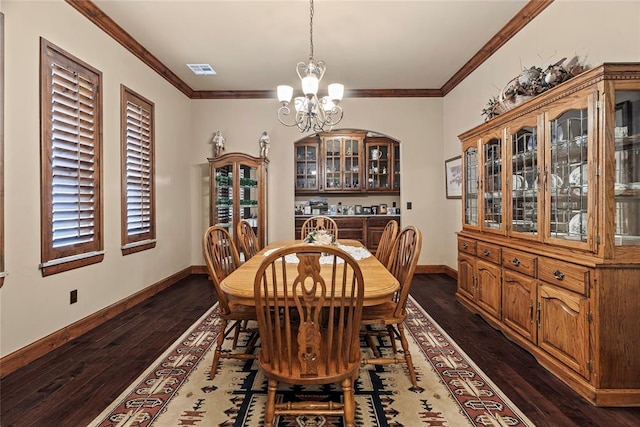 dining room with an inviting chandelier, dark hardwood / wood-style flooring, and ornamental molding