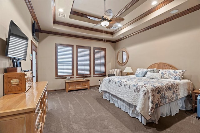 carpeted bedroom with crown molding, ceiling fan, and a tray ceiling