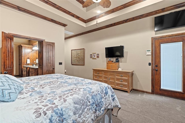 carpeted bedroom with ceiling fan, ornamental molding, and a tray ceiling