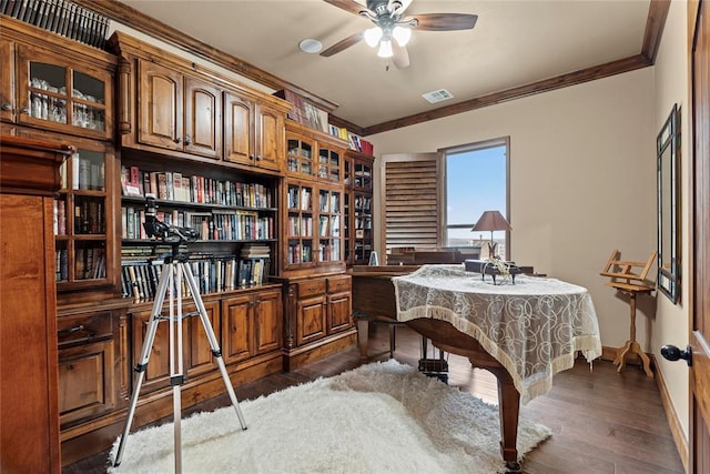 office space with ceiling fan, ornamental molding, and dark wood-style flooring