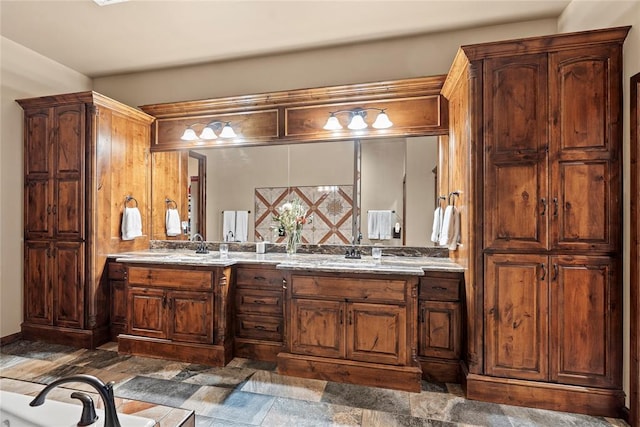 bathroom with stone finish flooring and double vanity