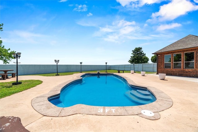 view of pool with a fenced backyard and a patio