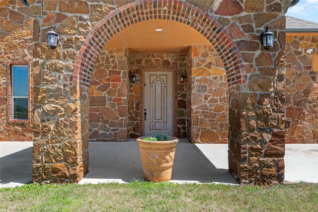 entrance to property featuring stone siding