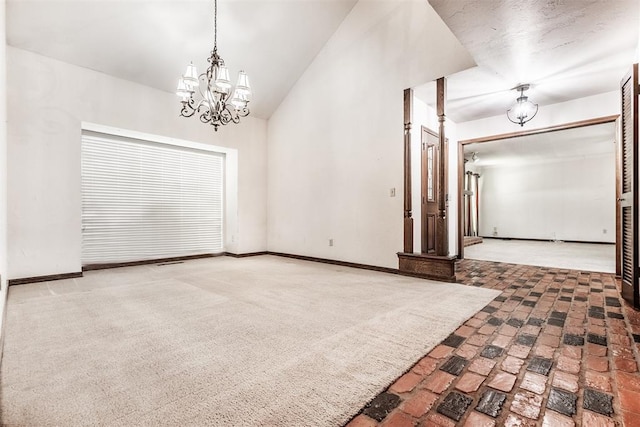 empty room featuring a notable chandelier and vaulted ceiling