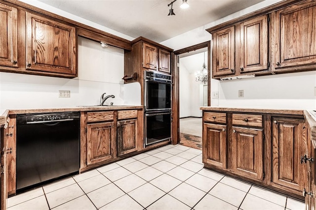 kitchen with light tile patterned flooring, sink, and black appliances