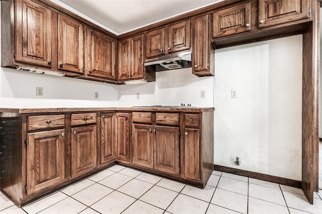 kitchen with light tile patterned floors and gas cooktop