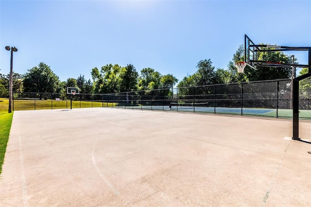 view of sport court featuring tennis court