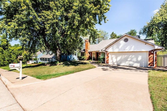 view of front of home with a garage and a front yard