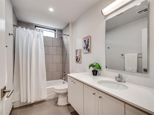 full bathroom with shower / tub combo with curtain, vanity, tile patterned flooring, and toilet