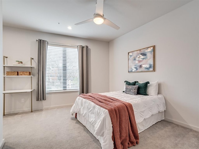 bedroom with light carpet and ceiling fan