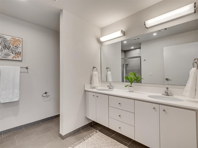 bathroom with tile patterned flooring, vanity, and a shower with shower door