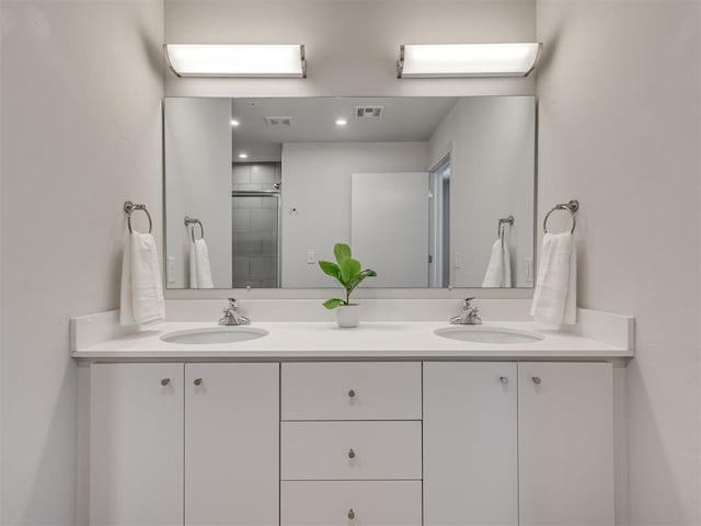 bathroom with vanity and a shower with door