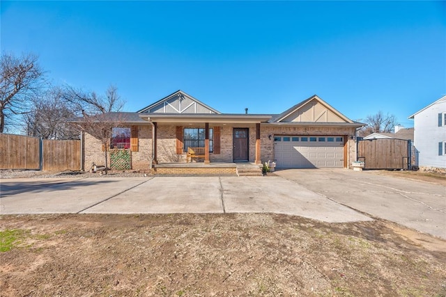 ranch-style house featuring a garage and covered porch