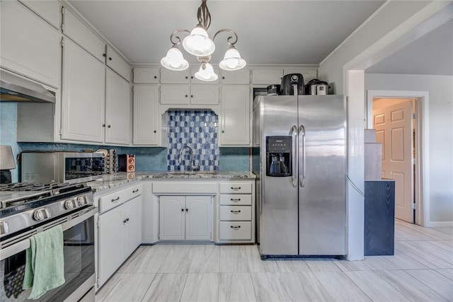 kitchen with decorative light fixtures, stainless steel appliances, decorative backsplash, and white cabinets