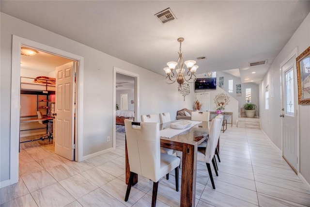 dining space with a notable chandelier