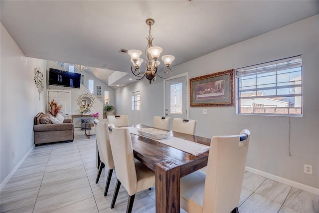 dining room with an inviting chandelier and a healthy amount of sunlight